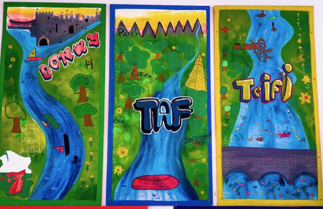 Painted murals of Welsh rivers Conwy, Taf and Teifi which represent the houses of the school