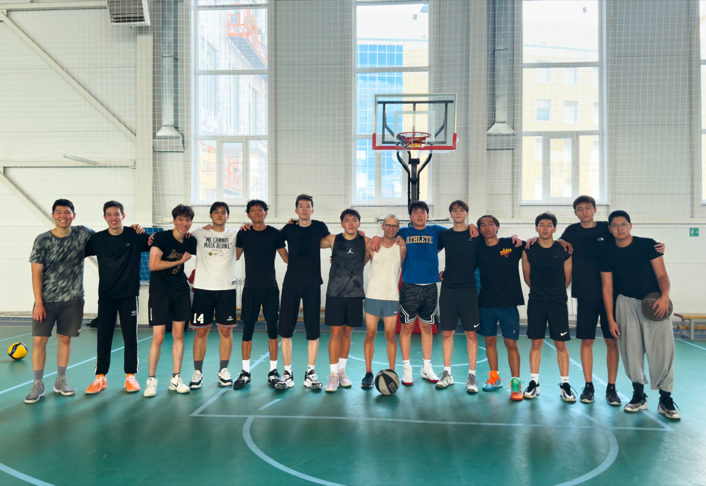 The basketball group in the sports hall after playing, lined up across the
court