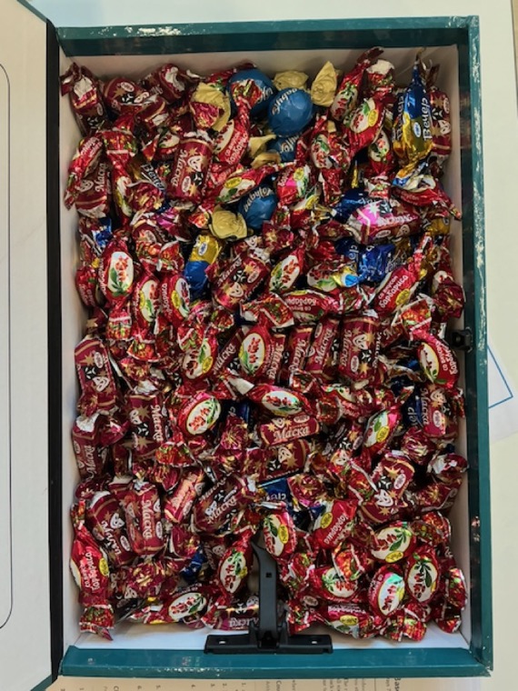 An open box of individually wrapped
chocolates
